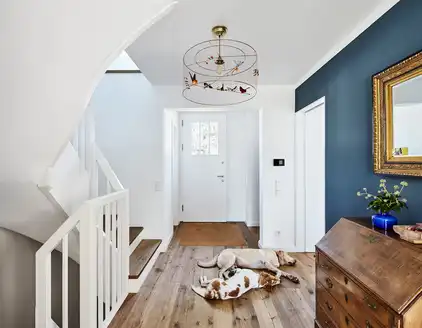 heller Flur, Wand in petrol rechts und weiße Treppe links